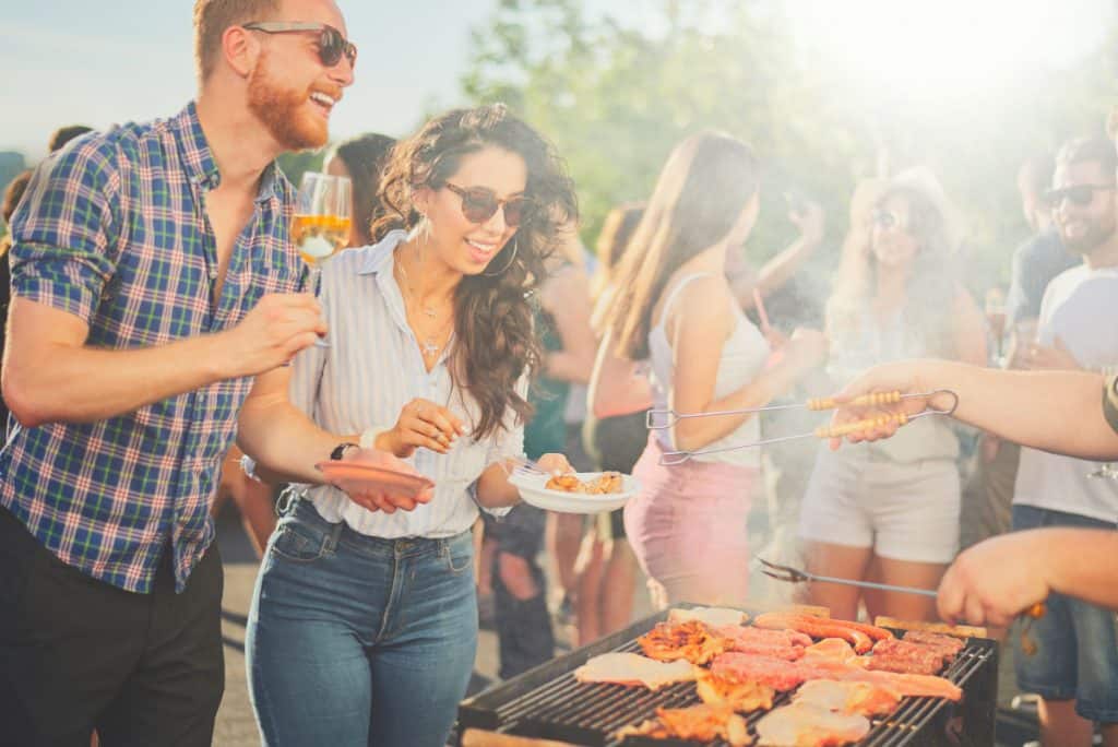 A group of people gathered around a barbecue grill