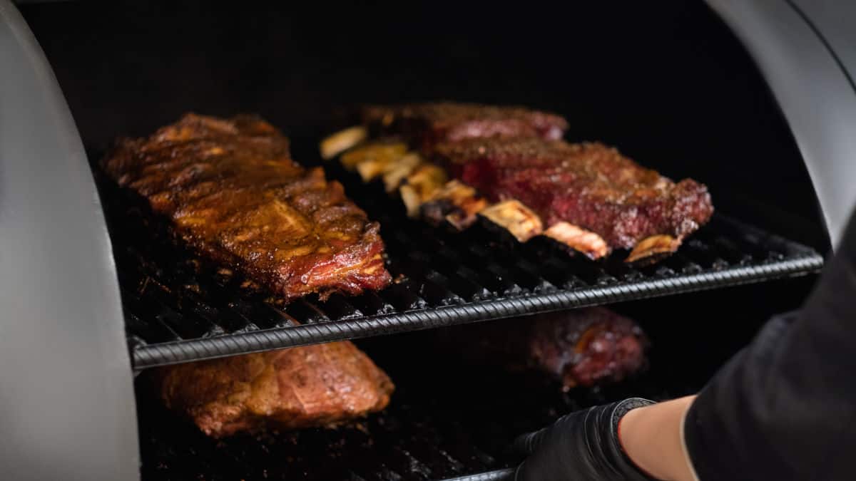 Ribs barbecuing smoking in a large smoker