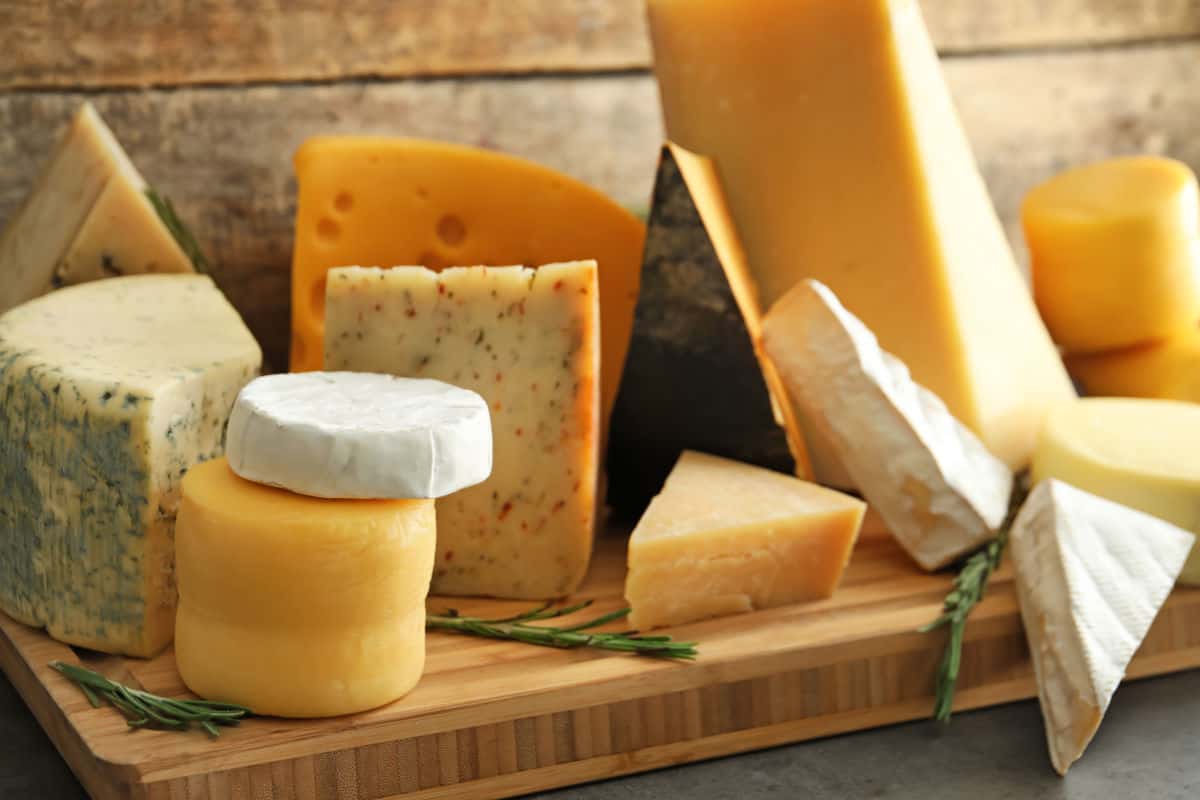 A selection of different cheeses on a chopping board