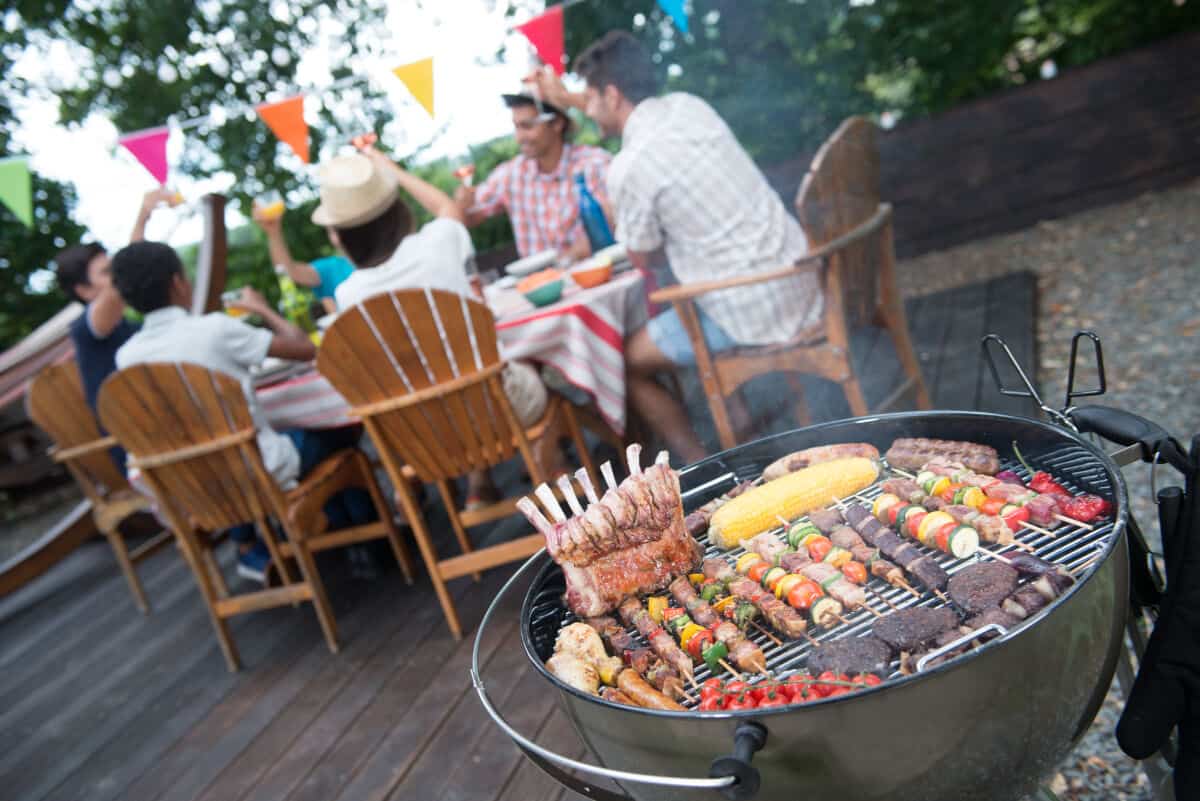 A wide angle shot of cookout attendees at an outdoor table