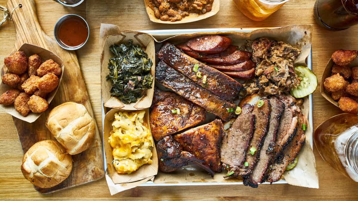 A mixed bbq platter, photo'd from above on a wooden surface