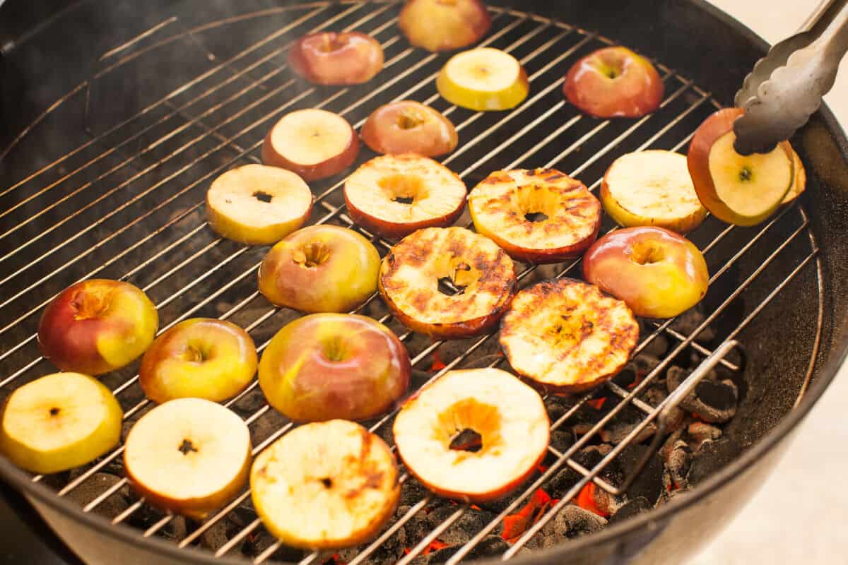 Apple and pineapple on an outdoor grill