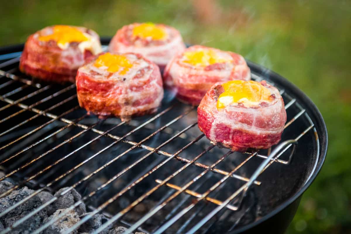 bacon wrapped burgers indirect heat cooking on a charcoal grill