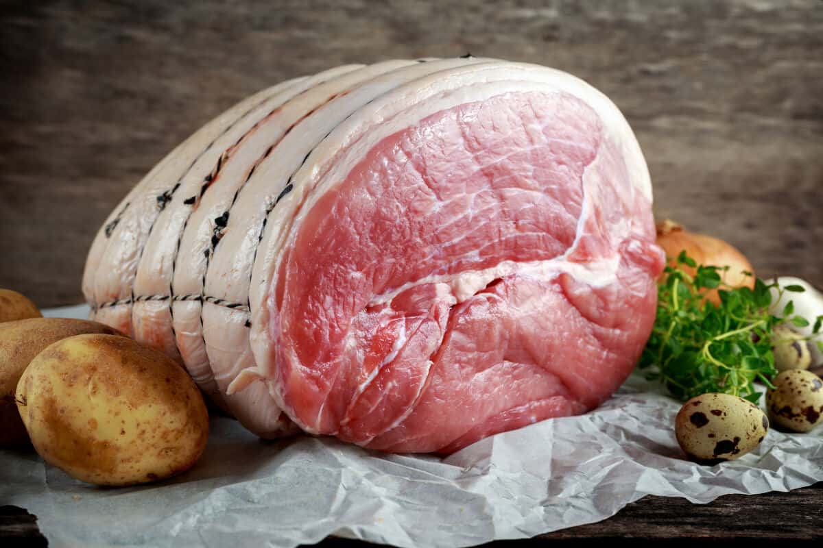 A raw gammon ham on butcher paper