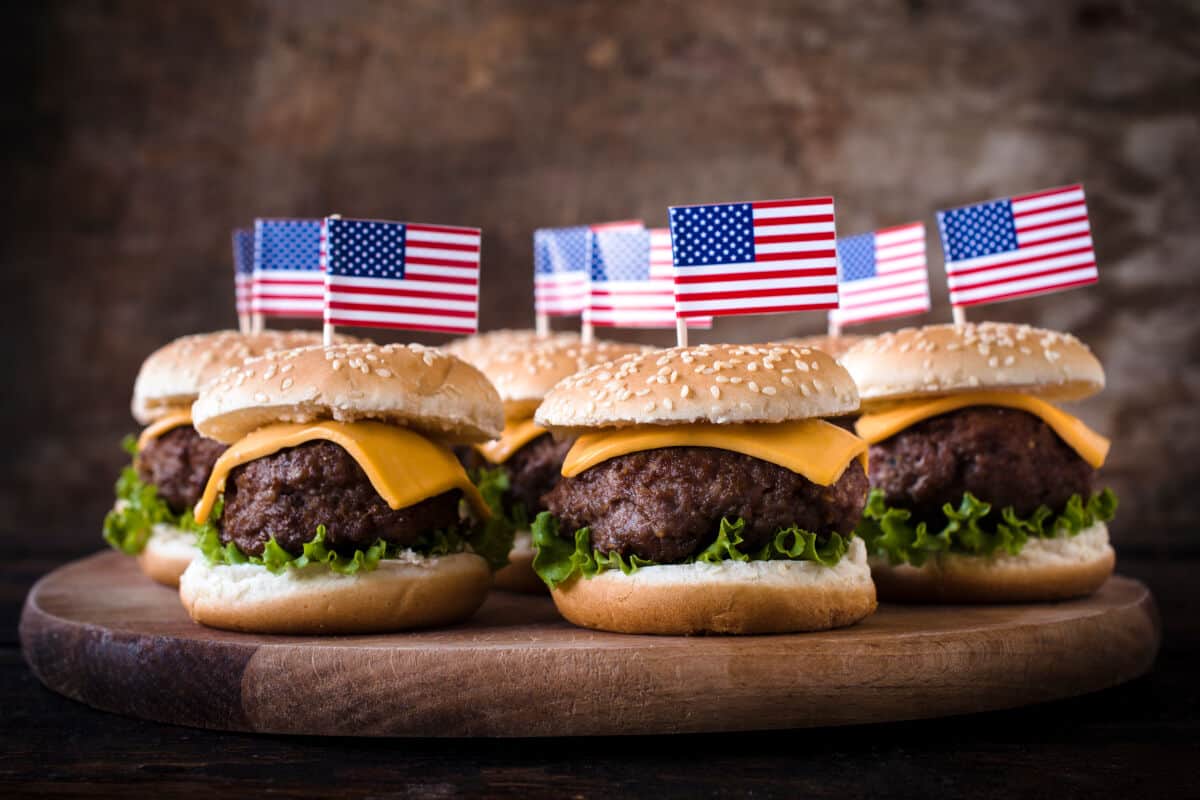 Cheeseburgers with american flags stuck in them