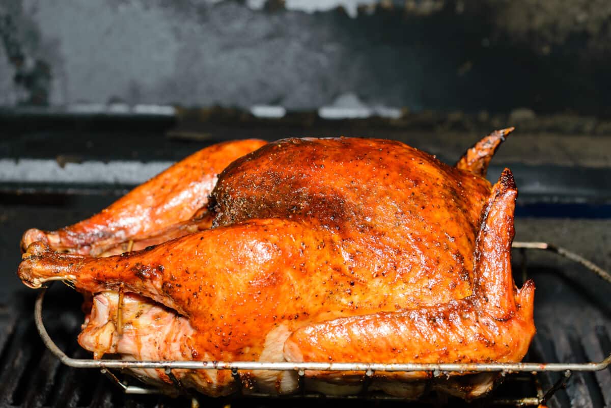 A smoke roasted chicken, still inside of a smoker