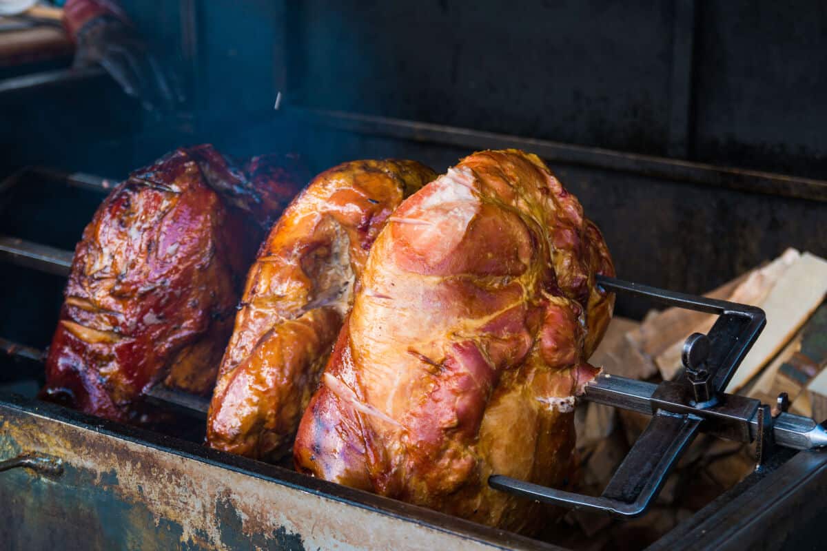 Three hams inside a smoker