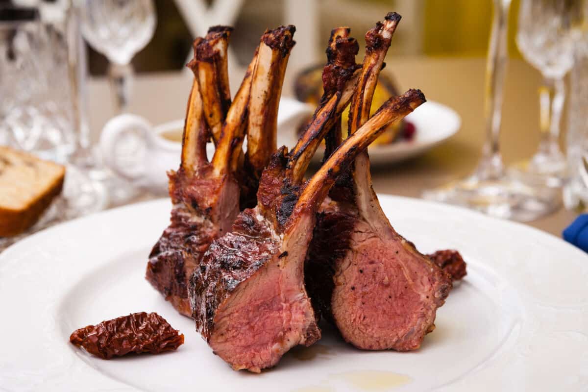 Perfectly smoked rack of lamb, cut in half showing pink inside