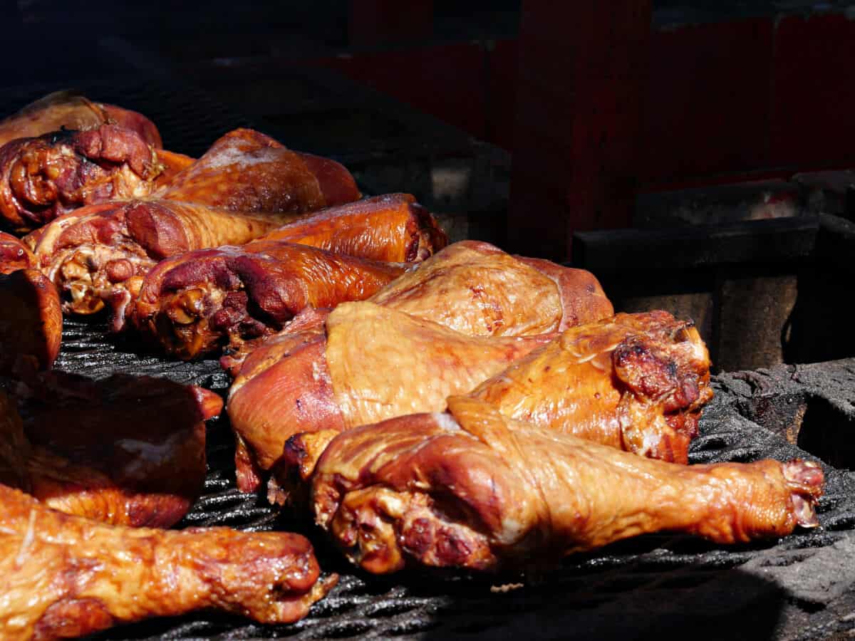 turkey legs inside a barbecue smoker