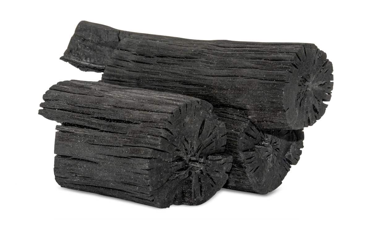 2 log shaped lumps of hardwood lump charcoal isolated on white