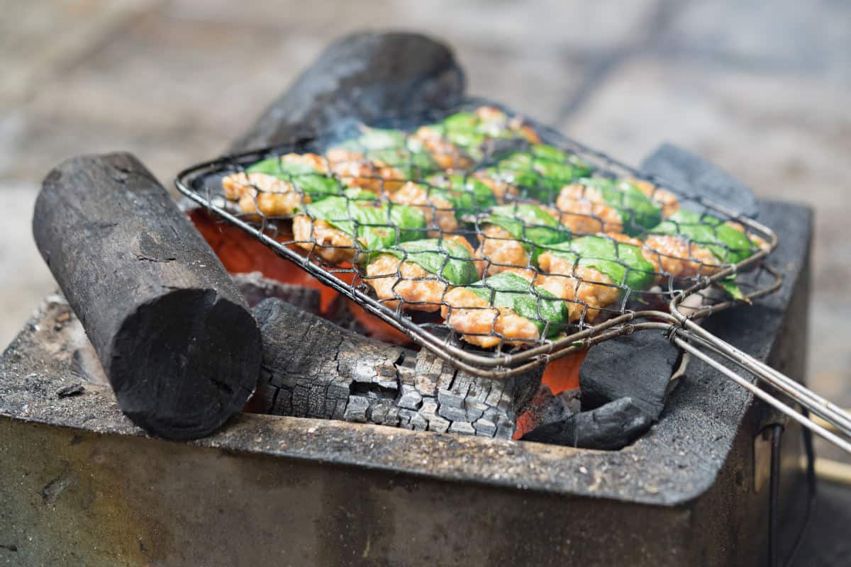 Leaf wrapped chicken in a grill basket