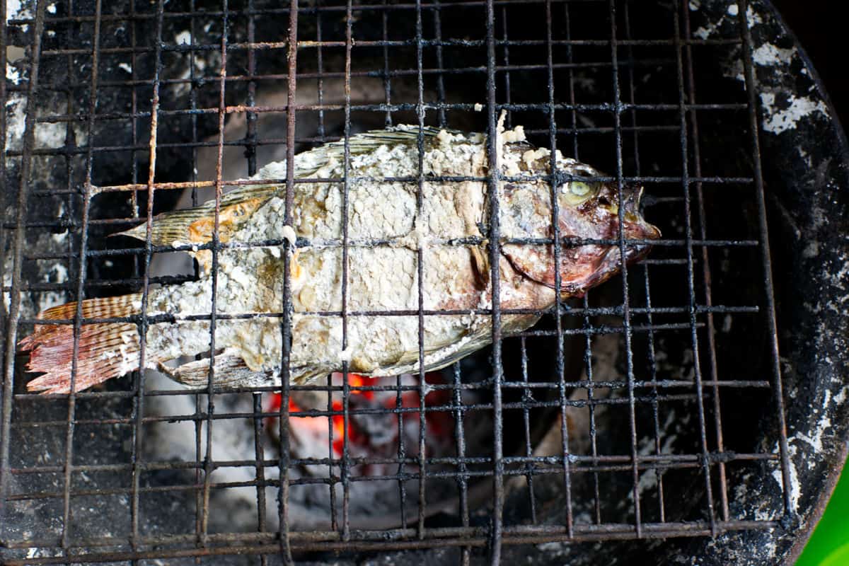 Fish in a grill basket over charcoal