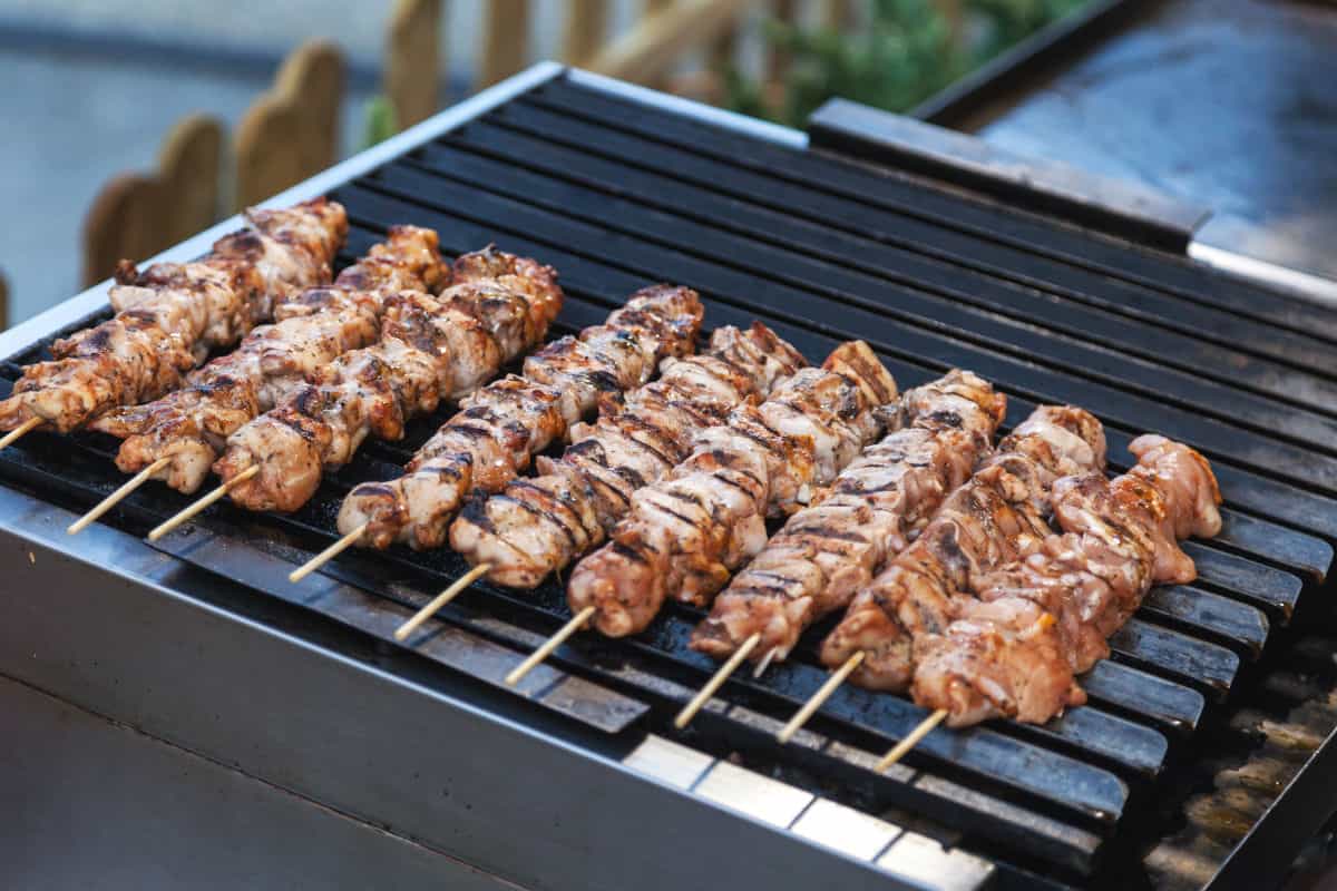 kebobs being grilled on an outdoor electric grill