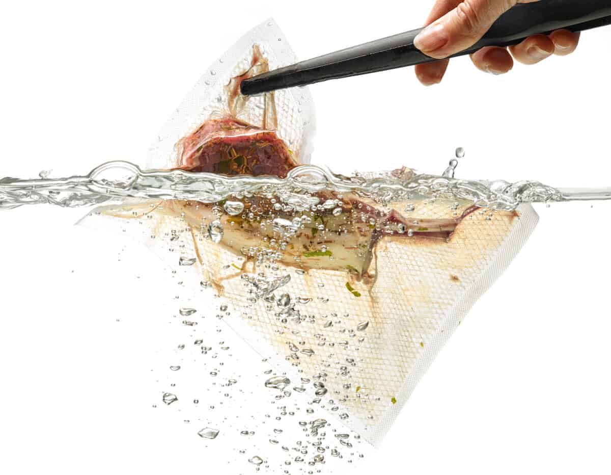Ribs in a vauum sealed bag being dropped into water