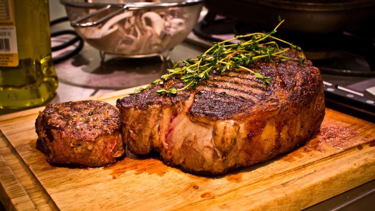 A large cut of beef on a cutting board after being reverse seared